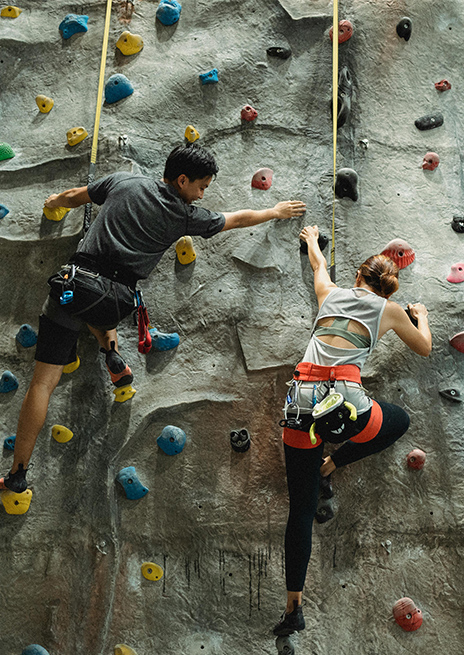 Couple rock climbing together at one of the most unique date night spots in Toronto, perfect for adventurous couples