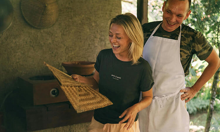 Couple smiling during a hands-on cooking class, a perfect interactive date night experience