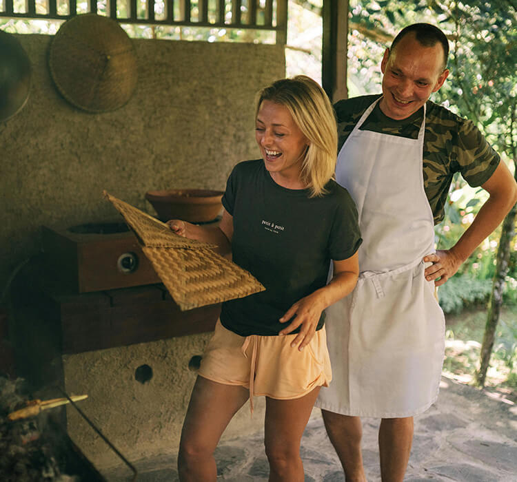 Couple smiling during a hands-on cooking class, a perfect interactive date night experience