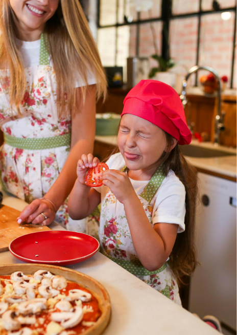 Mommy-daughter making homemade pizza together as a sweet and memorable date night activity for families