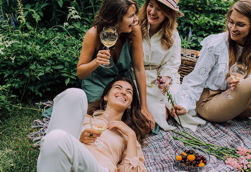 Group of friends enjoying a relaxing picnic, perfect for a DIY date night or low-key experience
