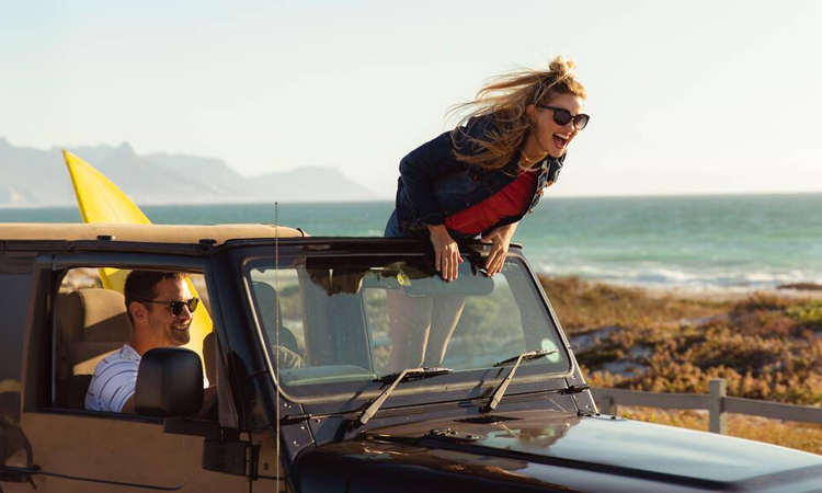 Couple in a jeep on a road trip in California for a date.