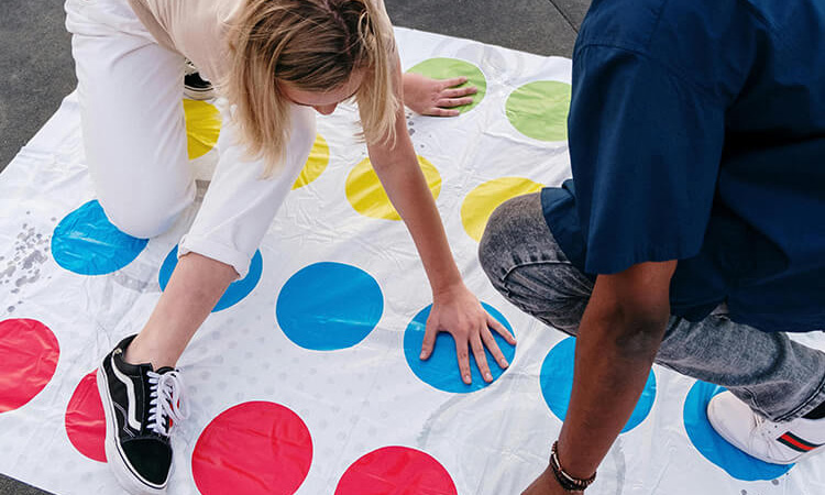 Couple playing Twister outside, a playful and creative date night idea to break the ice
