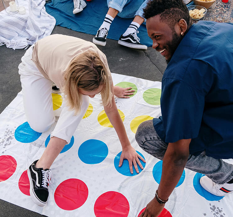 Couple playing Twister outside, a playful and creative date night idea to break the ice